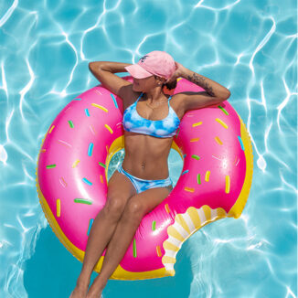 Young woman relaxing on a pool floaty