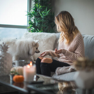 Woman and her dog relaxing in a cozy home